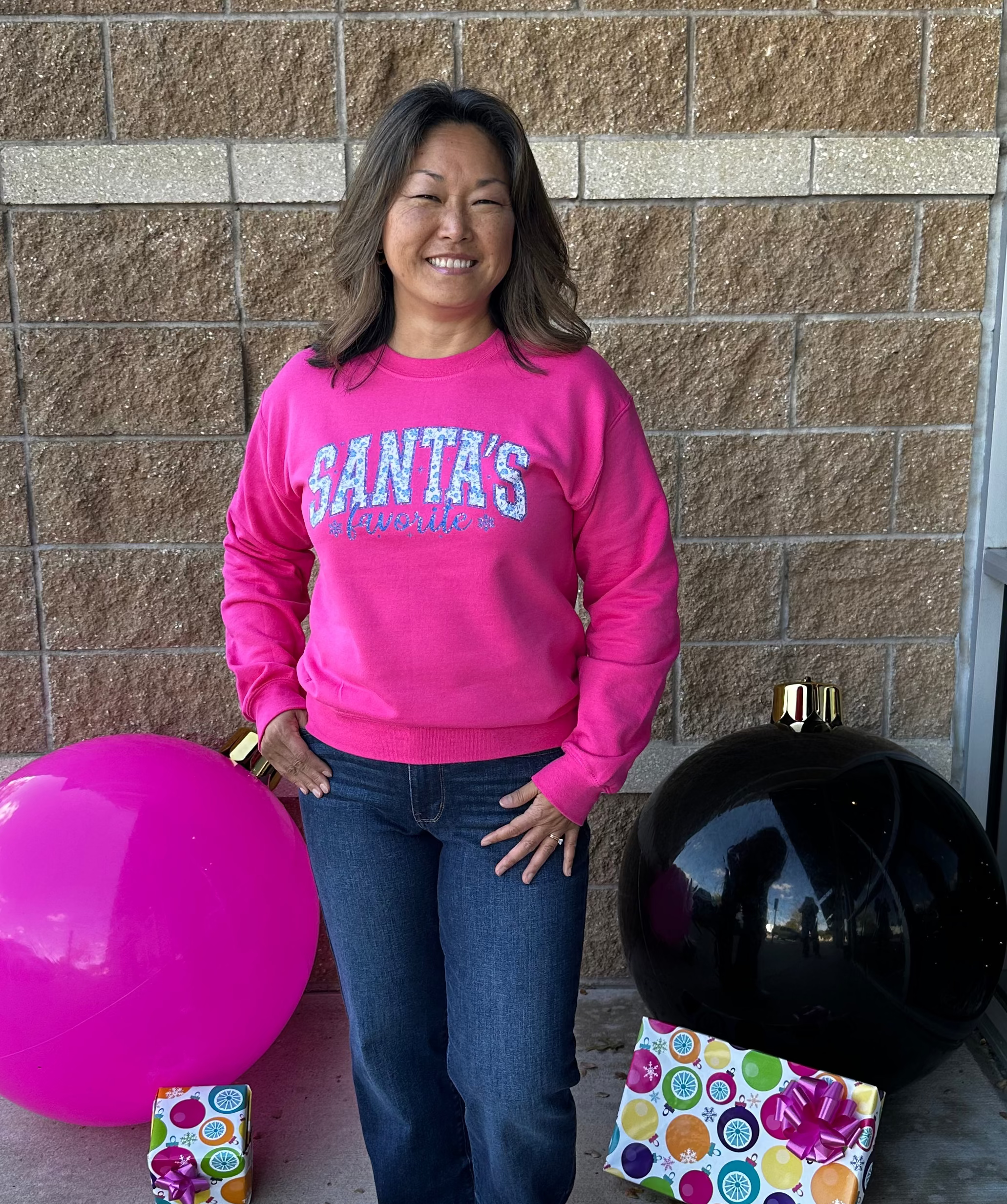 Pink sweatshirt with Santa's Favorite written on the front
