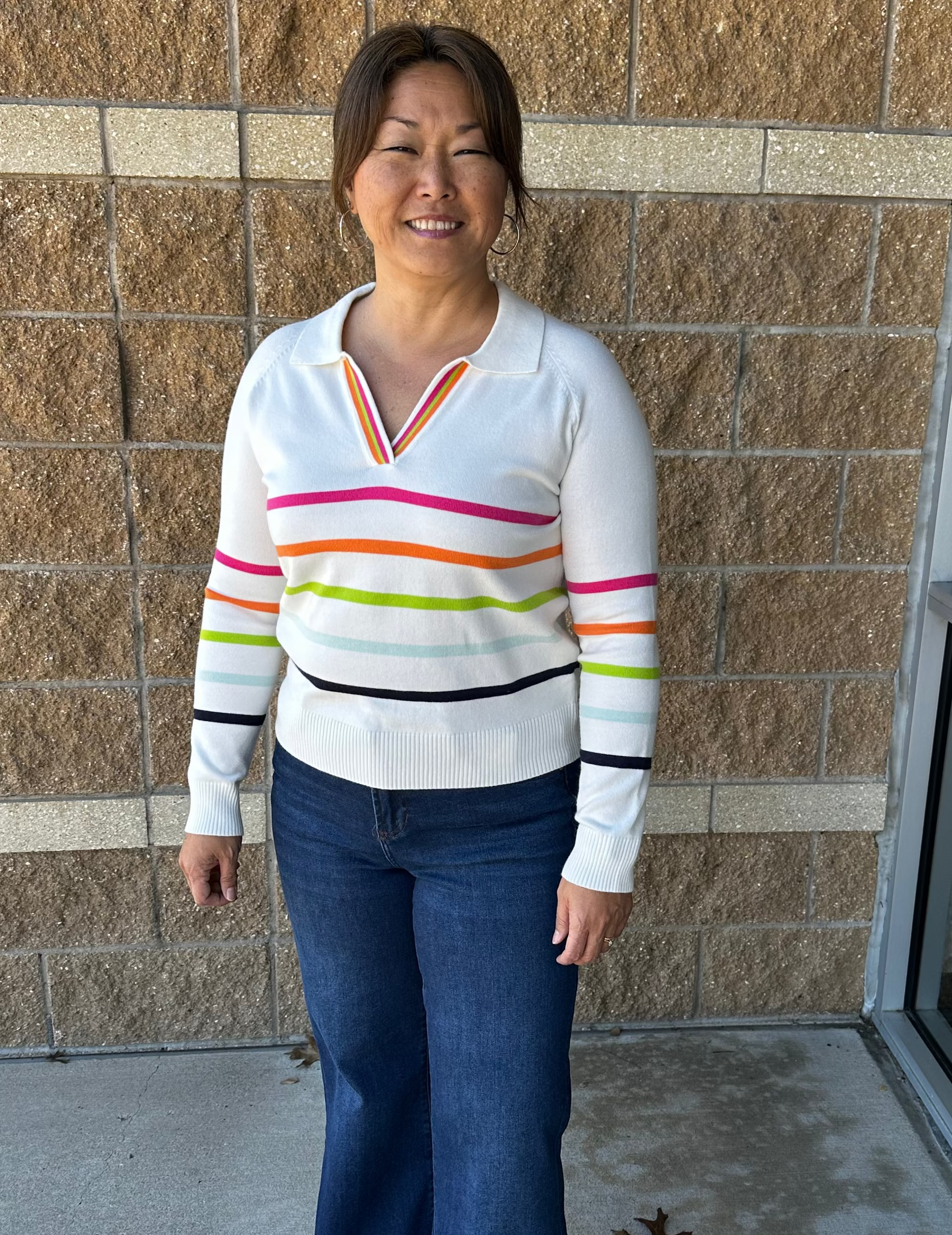 White sweater with bright colored stripes