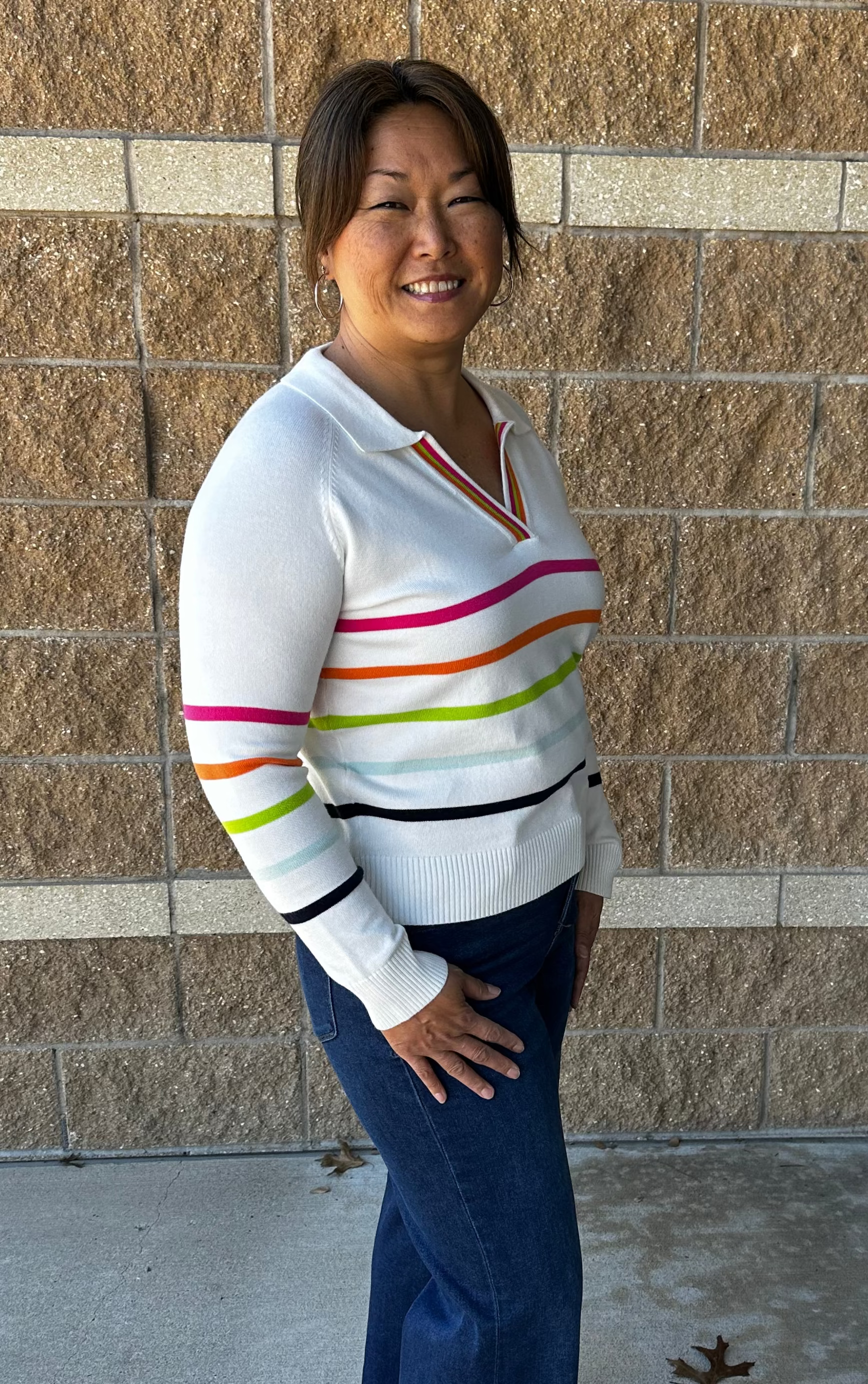 White sweater with bright colored stripes