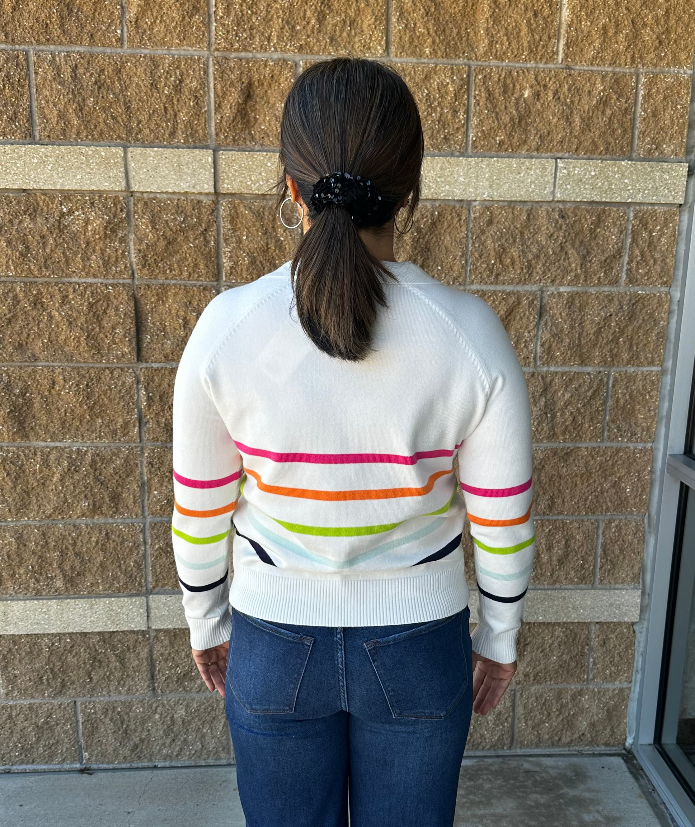 white sweater with bright colored stripes