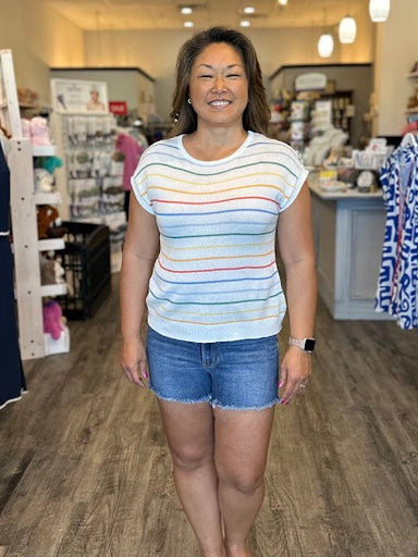 Short sleeve white sweater with multi color stripes.