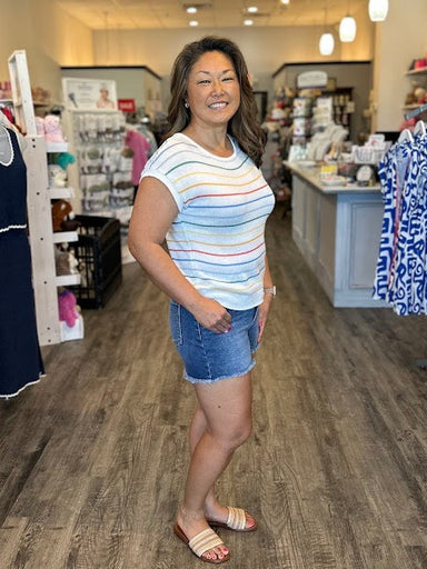 Short sleeve white sweater with multi color stripes.