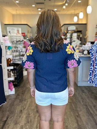 Navy Top with floral embroidery and puff sleeves