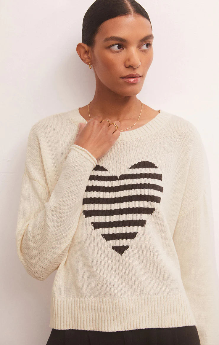 Cream long sleeve sweater with a striped heart on the front. 